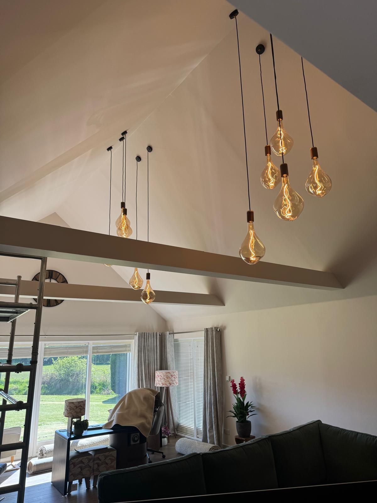 A cluster of filament pendants in a vaulted living room